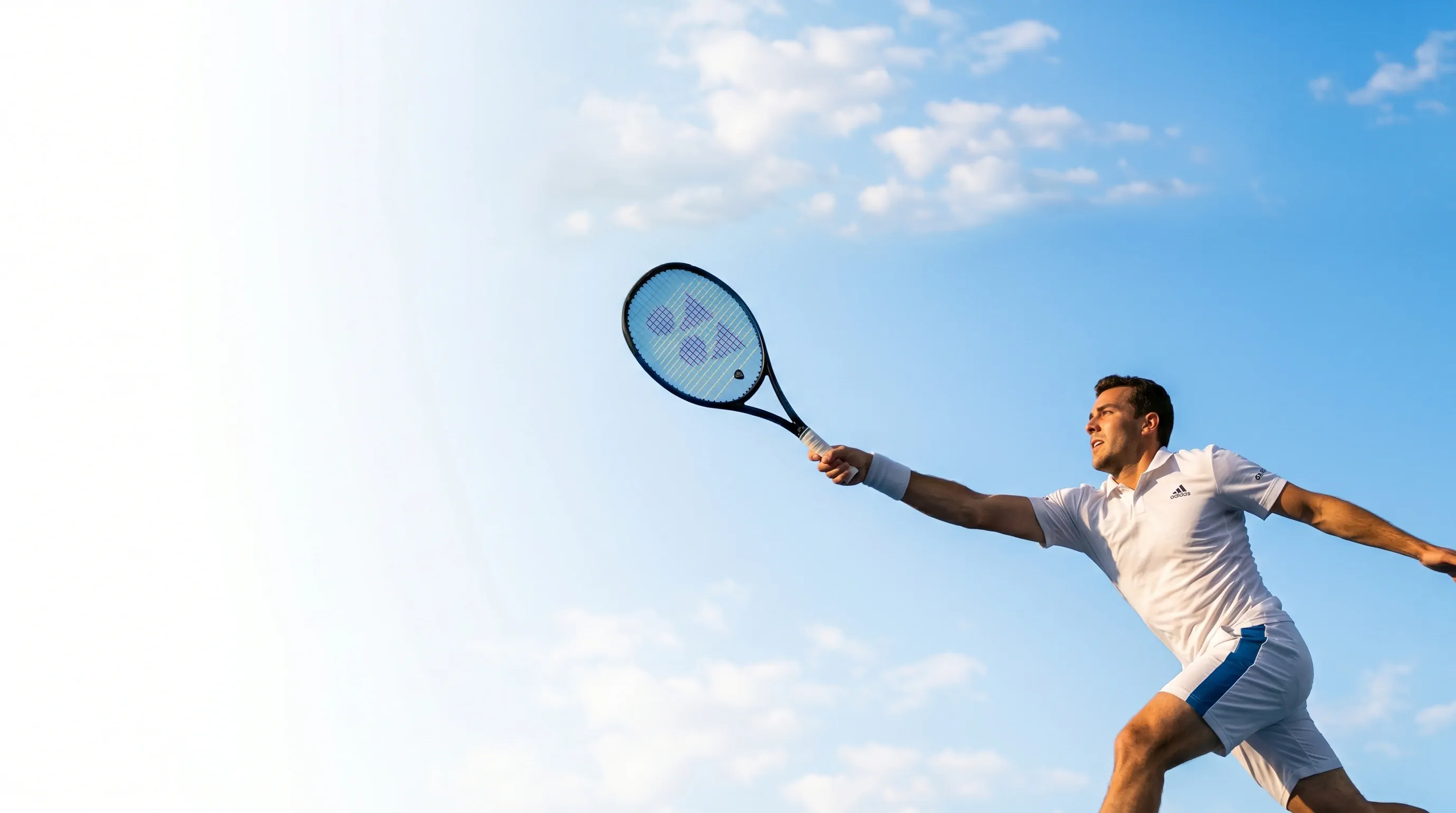 Player lunging for a shot on a hard court