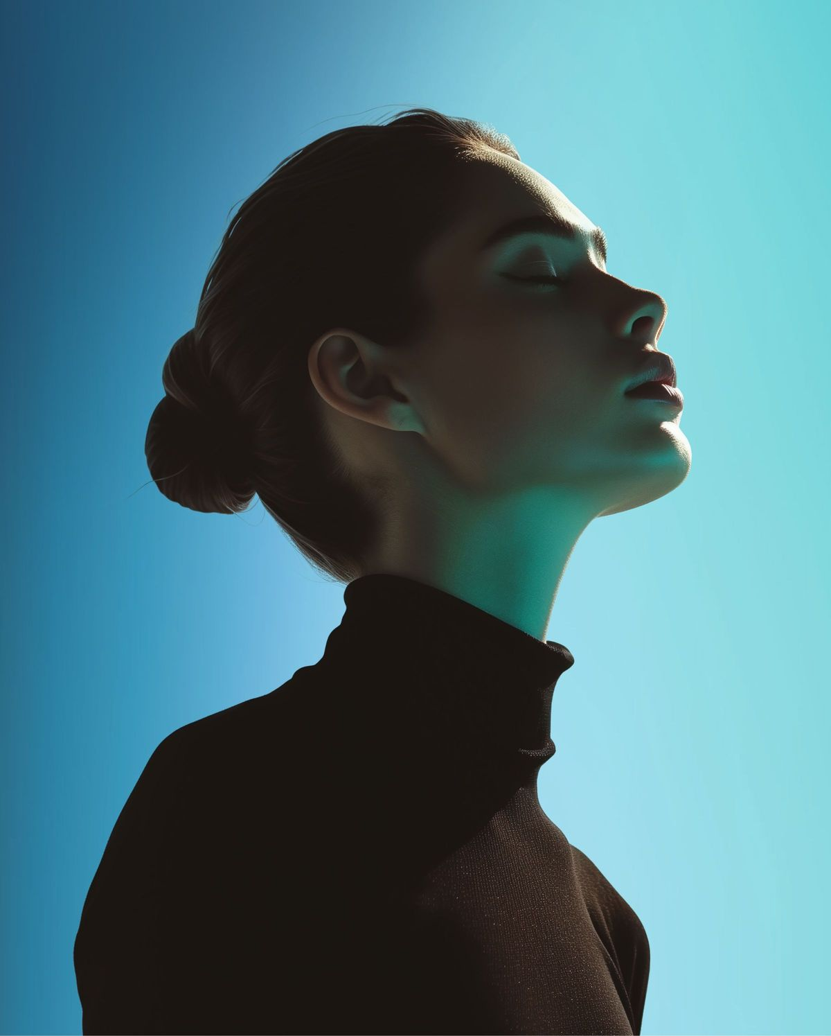 A figure lit in teal, face turned toward the light